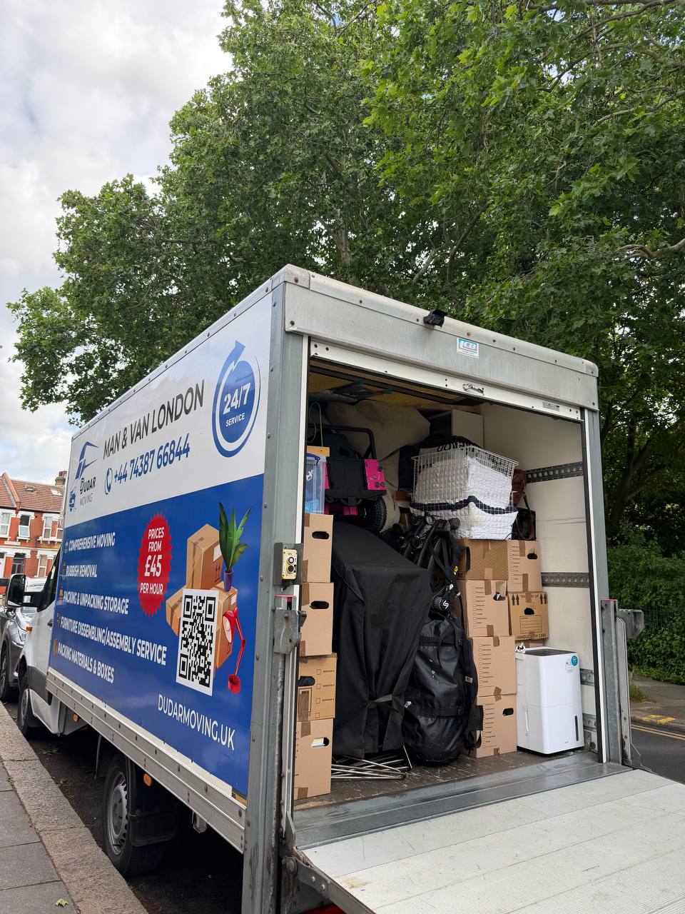 A Luton van loaded with neatly stacked boxes and secured belongings