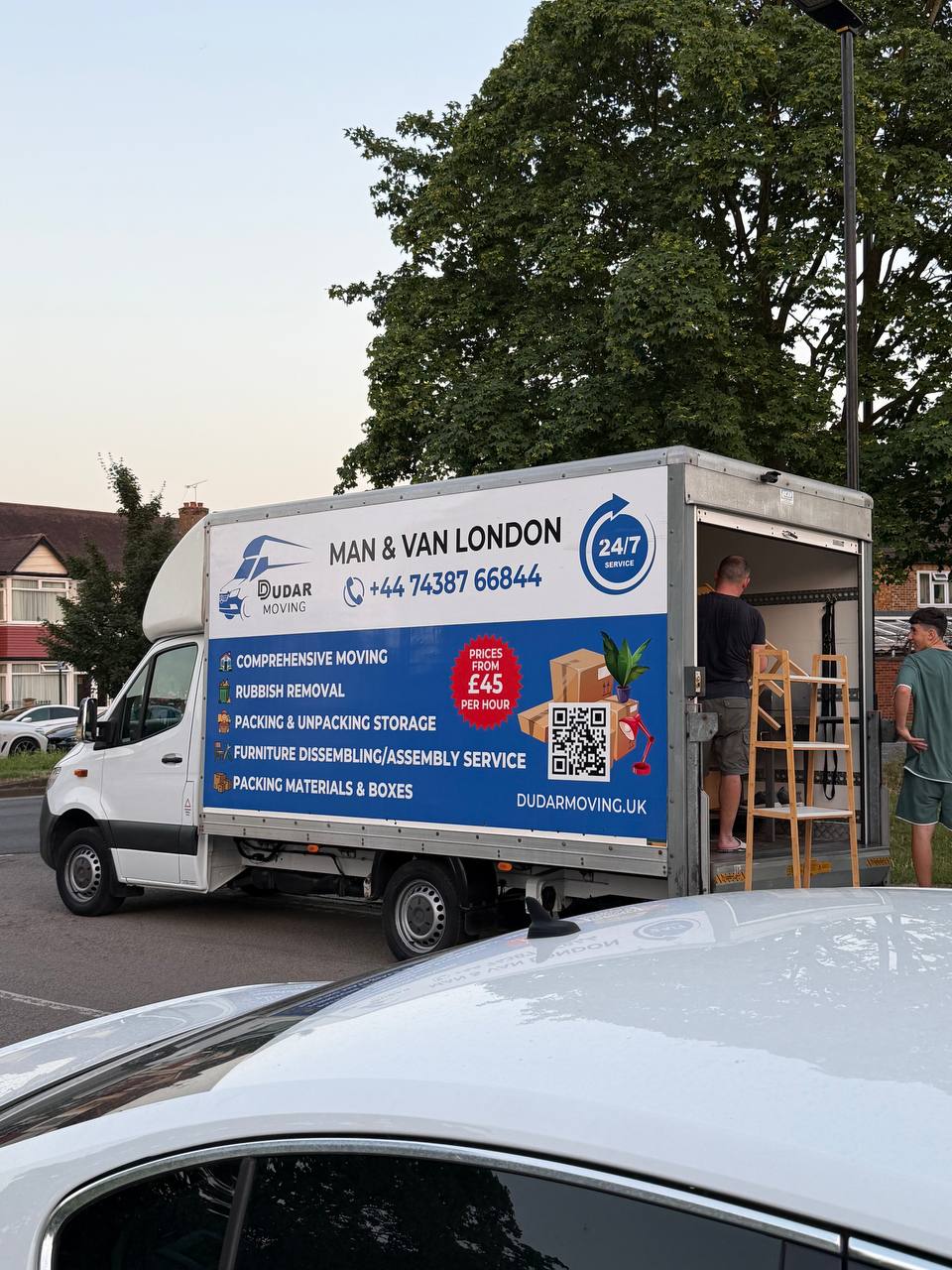 The crew loading furniture into a Luton van on a residential London street